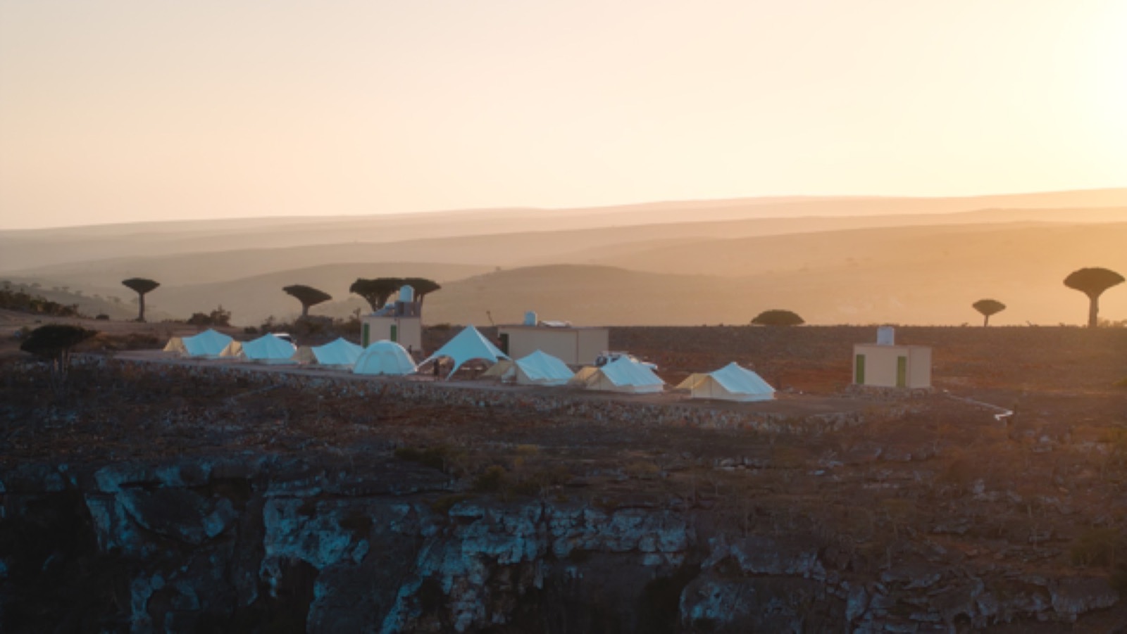 White tented camp on the plateau at dusk