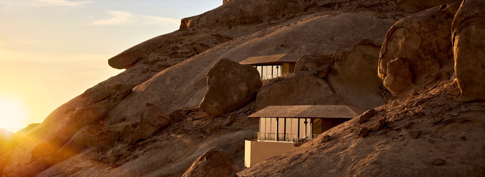Rock walls and a desert resort at sunset