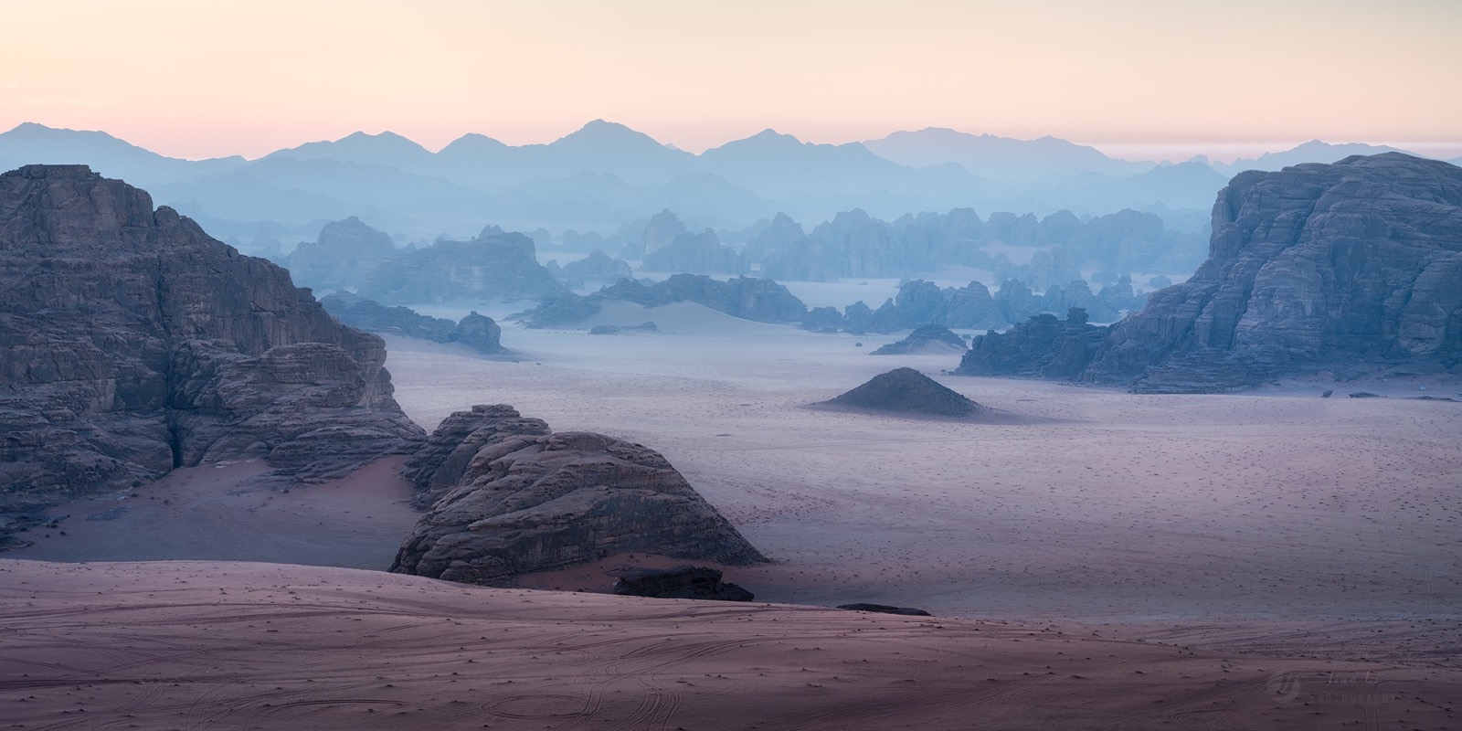 Morning mist and layered rock across the wilderness