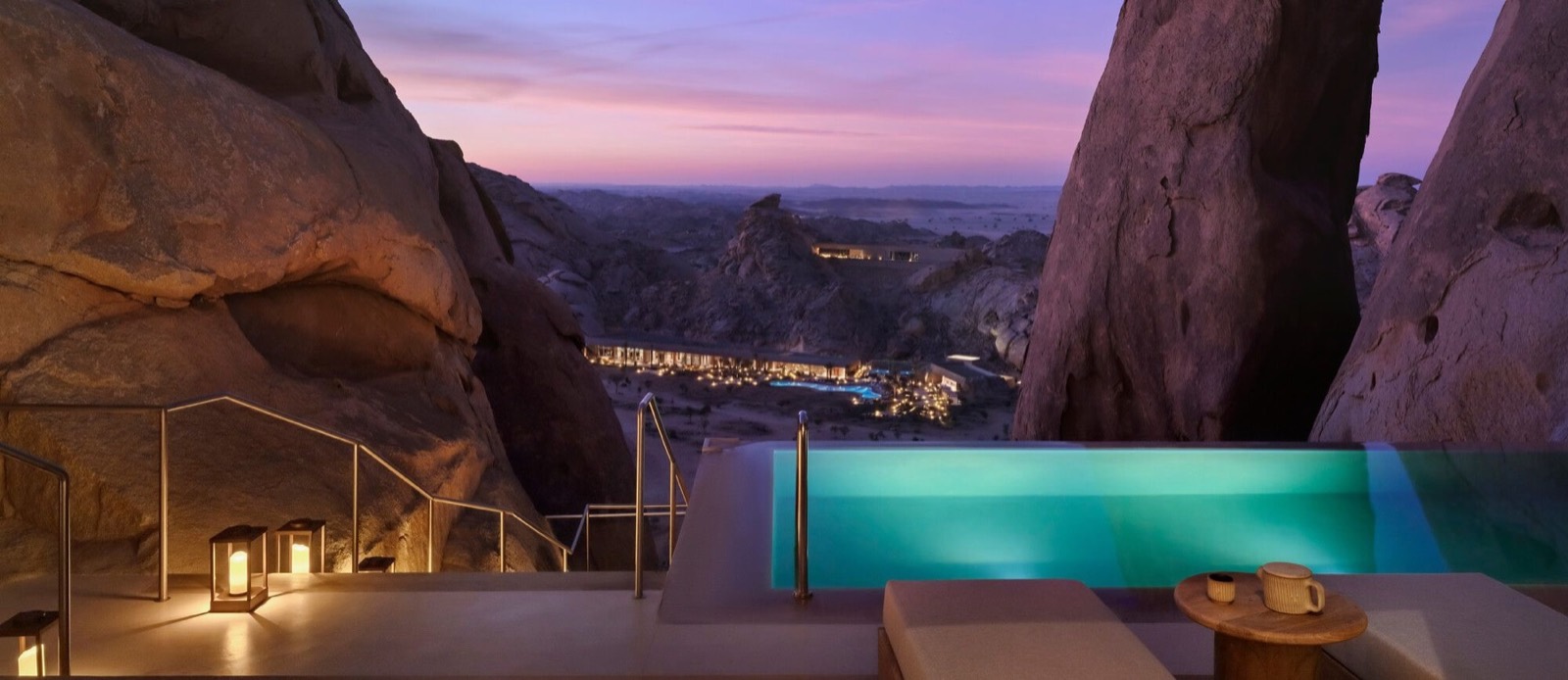 A resort set into the desert cliffs, pool at dusk