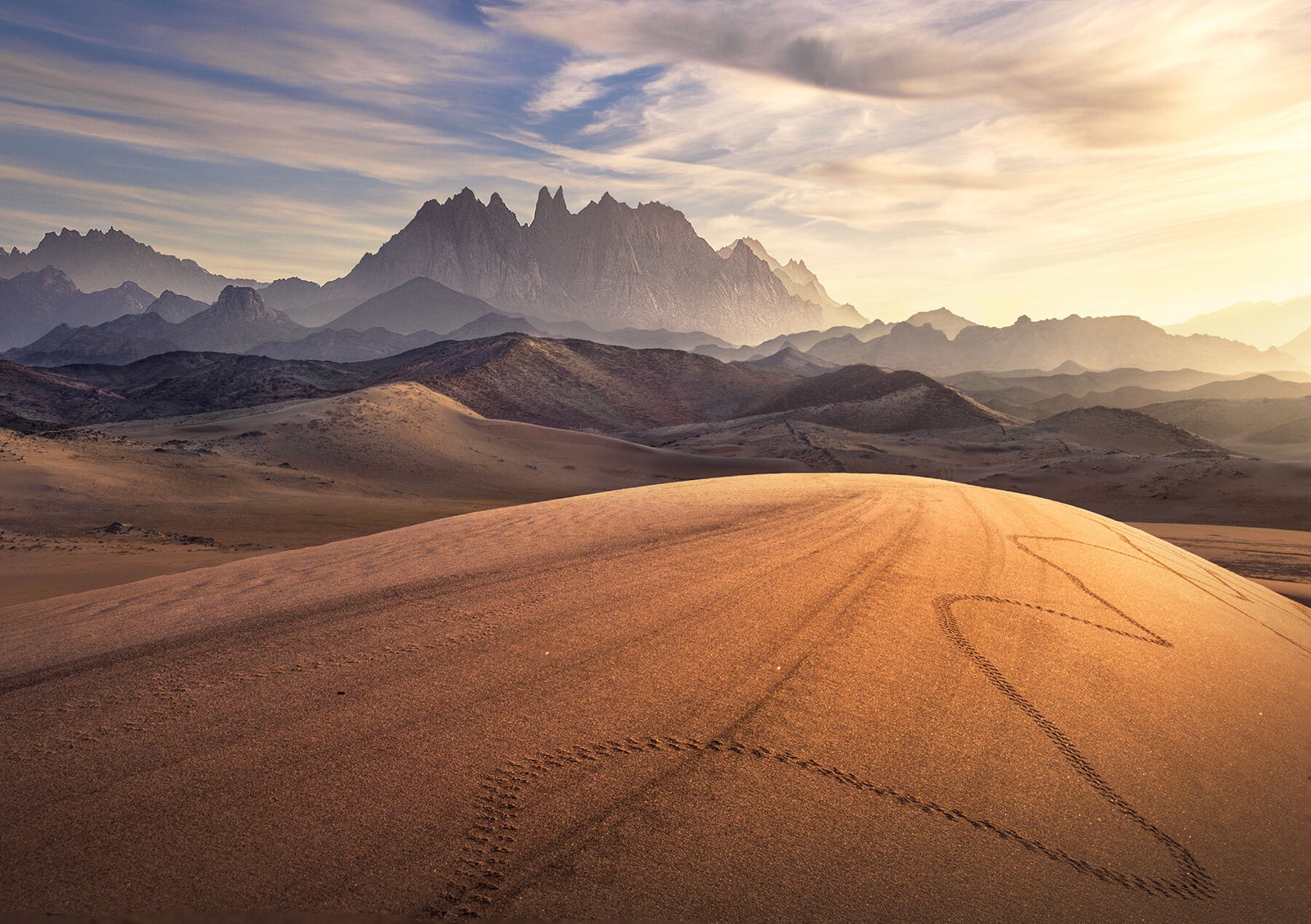 Golden dunes and distant mountains
